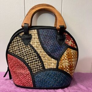 Super cute colorful woven bag with wooden handles.